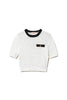 Maglia cropped neve-nera con bottone Oval T